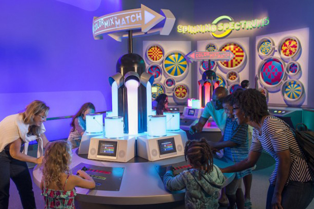 People interacting with paint brushes and cans at Innoventions at Disney Epcot Center